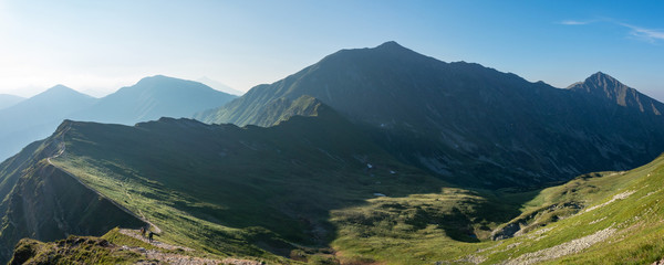 Obraz premium Panorama of amazing morning summer mountains with hikers