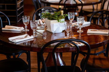 Glasses, napkin and tableware on table in restaurant