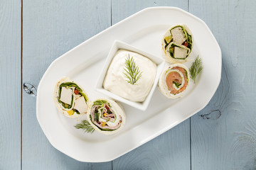 Mix of wraps with ham, chicken, salmon and crab served