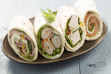 Mix of wraps with ham, chicken, salmon and crab served