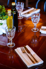 Catering table set  with silverware, napkin and olive oil