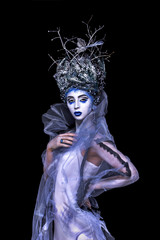 Winter woman with creative makeup and brunches in head