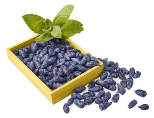 Honeysuckle berry fruits in a wood box