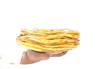 One hand holds the pancakes