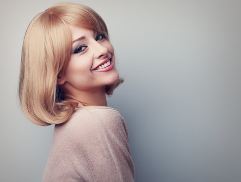Beautiful tooth smiling woman with short blond hair looking happ