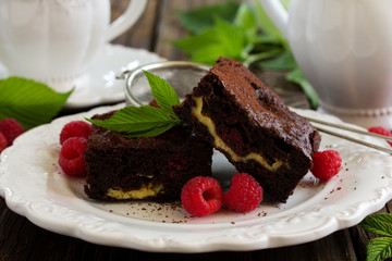 Brownie with raspberries and cheese filling.