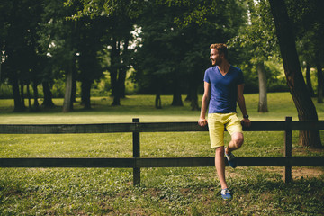 Young man by the wooden fence