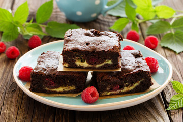 Brownie with raspberries and cheese filling.
