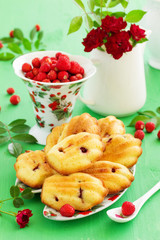 Madeleine cookies with wild strawberries. .