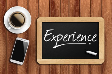 coffee, phone  and chalkboard with  word experience