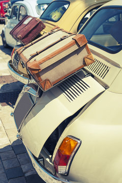 Vintage cars with brown suitcase