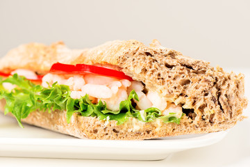 Prawn sandwich on white plate