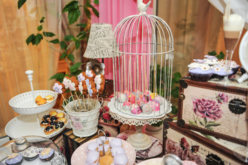 Wedding decoration with pastel colored cupcakes, meringues, muffins and macaroons.