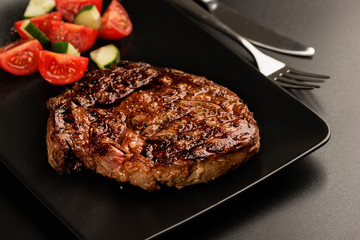 Grilled steak and vegetables on plate