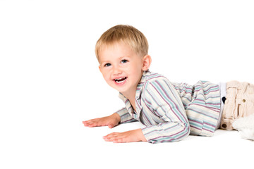 Boy shot in the studio on a white background laying smiling