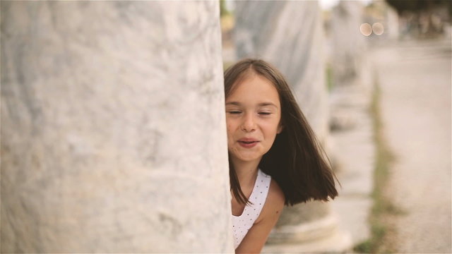 Little girl playing hide and seek