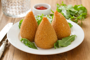 appetizer on white plate on brown background