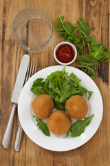 appetizer on white plate on brown background