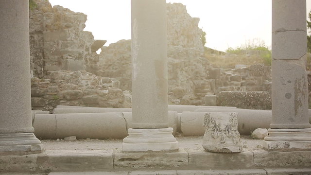 Child jumps on the stone ruins of the Roman era