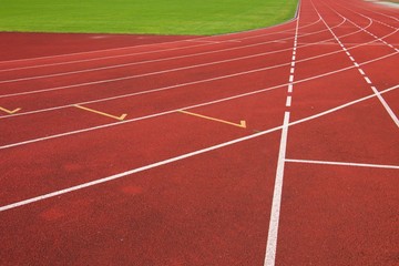 Fototapeta premium Red running racetrack on the athletic stadium
