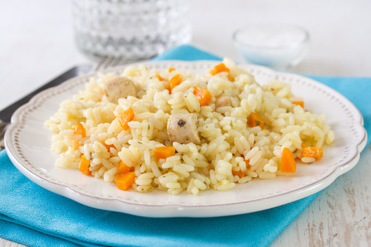 rice with meat and vegetables on white plate