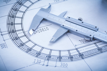 Steel slide caliper on blueprint horizontal version construction