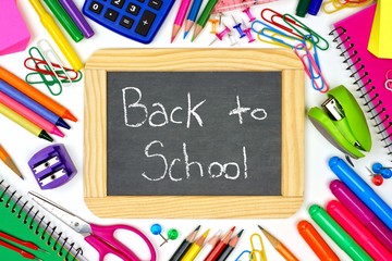 Back to School chalkboard on a white background with school supplies surrounding