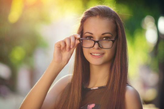 Outdoor photo from a beautiful young women in eyeglasses