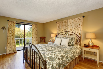 Timeless bedroom with floral bedding and hardwood floor.