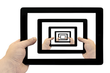 Tablet PC in hand looped on screen isolated on white