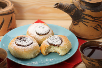 cottage cheese cakes  with jam on blue plate and tea set