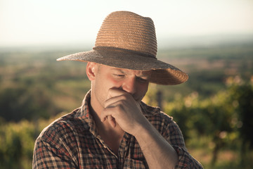 Portrait of male worried farmer in field