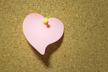 heart note paper taped on cork board background