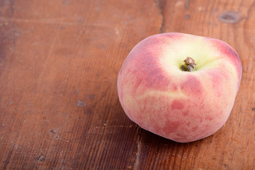 Peache on wooden plate