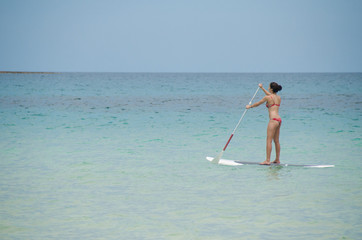 Girl paddling out on paddle board