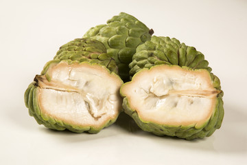 Some Sugar-Apples over a wooden table. Atemóia