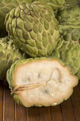 Some Sugar-Apples over a wooden table. Atemóia