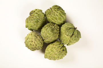 Some Sugar-Apples over a wooden table. Atemóia