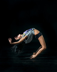 Fototapeta premium young ballet dancer dansing on black background