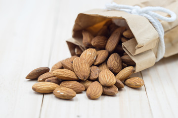 Almond on wood background.