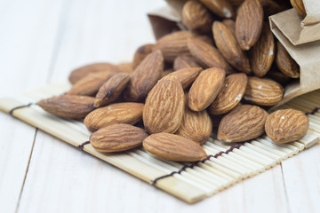 Almond on wood background.
