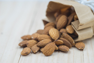 Almond on wood background.