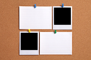 Polaroid style photo print frame two pair pinned to a cork notice board background with blank white office index filing card in a row