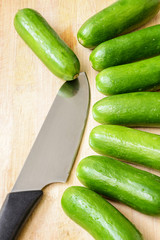 little cucumbers on the wooden board