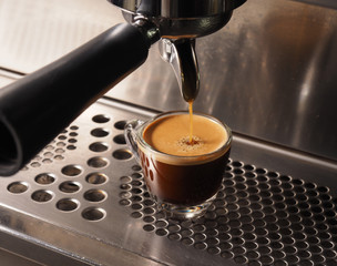 Hot coffee flow to a cup on espresso machine