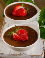 Homemade Chocolate Mousse with fresh berries on a rustic    wood