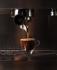 Hot coffee flow to a cup on espresso machine