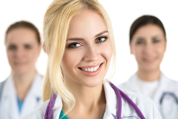 Portrait of young blonde female doctor surrounded by medical tea