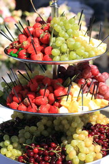 berries on festive table. strawberries, grapes, cherries on banquet