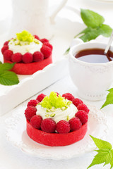 Tartlets with pistachio cream and raspberries.